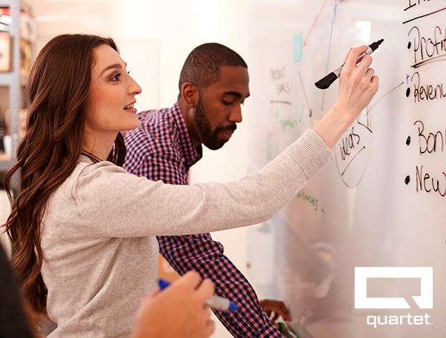 People writing on a Quartet Dry Erase Board